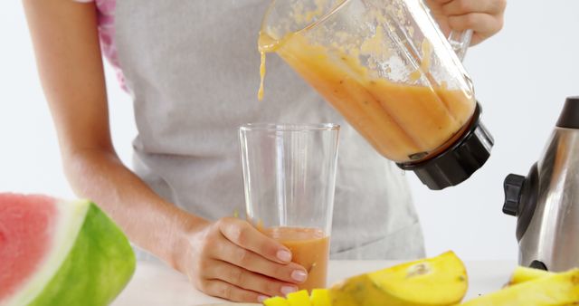 Person Pouring Fresh Smoothie into Glass in Kitchen - Download Free Stock Images Pikwizard.com