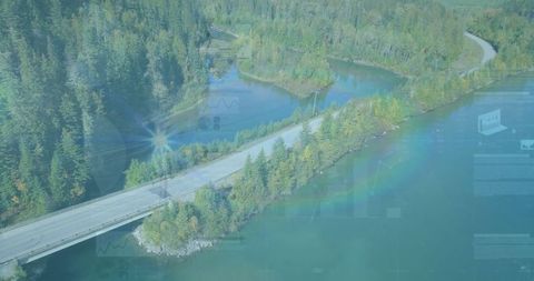 Aerial View of Winding Road Through Tranquil Lakeside Evergreen Forest