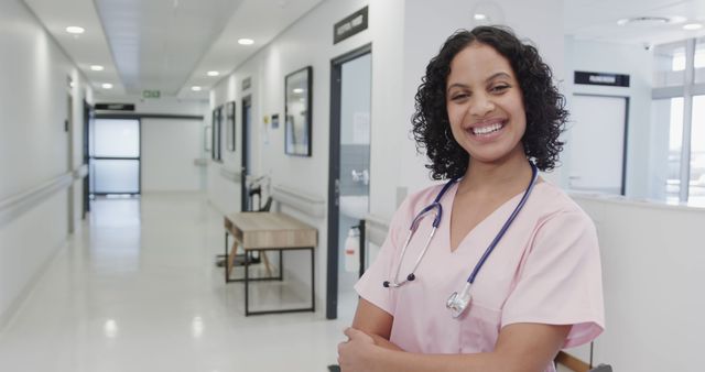 Smiling Nurse Standing in Hospital Corridor with Stethoscope - Download Free Stock Images Pikwizard.com