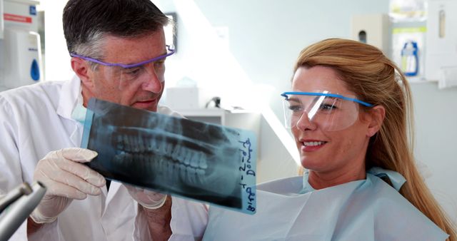 Dentist Showing Dental X-ray to Smiling Female Patient - Download Free Stock Images Pikwizard.com