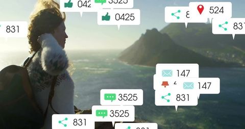 Hiker Overlooking Ocean with Digital Icons and Notifications