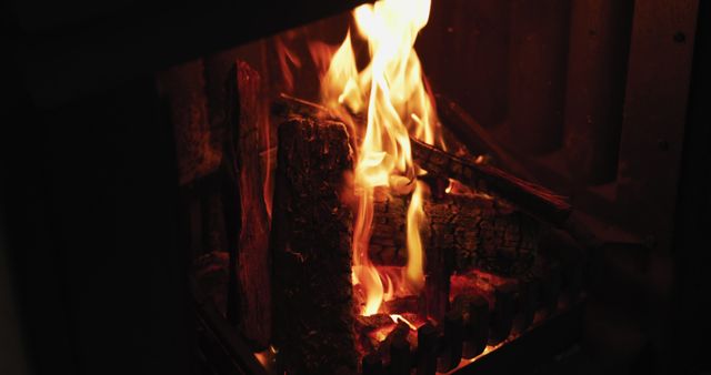 Close up of logs burning in a fireplace in the sitting room of a home - Download Free Stock Photos Pikwizard.com