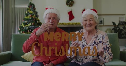 Happy Elderly Couple in Santa Hats Celebrating Christmas