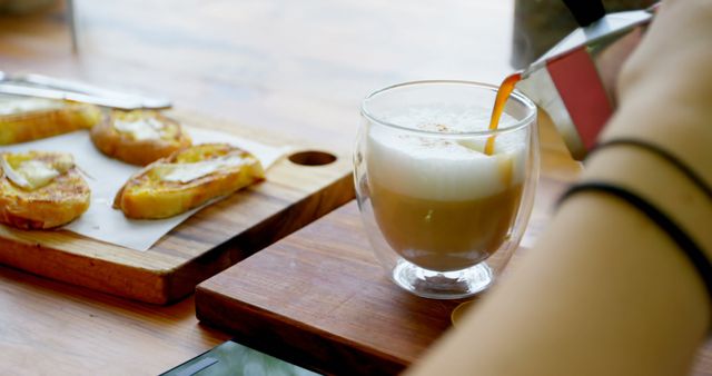 Pouring Fresh Coffee into Latte Glass Next to Breakfast Toasts - Download Free Stock Images Pikwizard.com