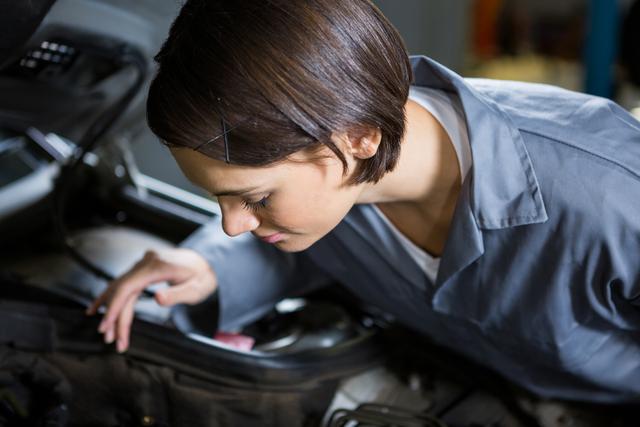 Female mechanic servicing car - Download Free Stock Photos Pikwizard.com