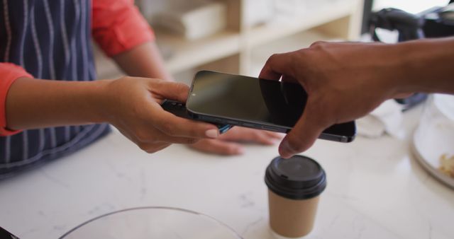 Customer using smartphone for contactless payment at coffee shop counter - Download Free Stock Images Pikwizard.com