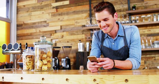 Smiling Barista Checking Phone in Rustic Café - Download Free Stock Images Pikwizard.com