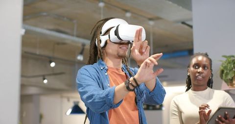 African American Team Demonstrating Virtual Reality Collaboration in Modern Office Space