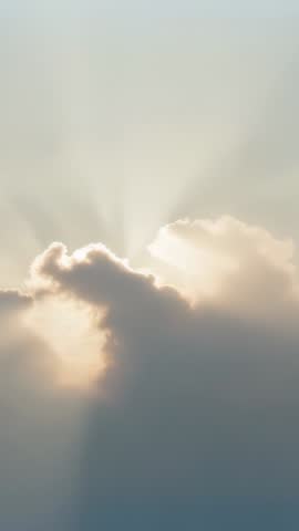 Sunbeams Peeking Past Scalloped Cloud Edge Forming Golden Crepuscular Rays Vertical Video