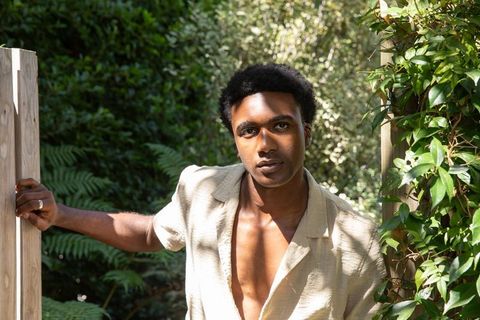 Man in Linen Shirt Relaxing in Garden Enclave