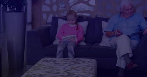 Grandfather and Granddaughter Bond With Books on Cozy Couch