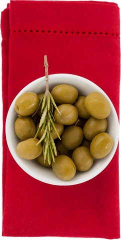 Transparent Bowl of Green Olives on Vibrant Red Napkin