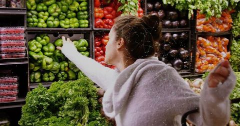 Shopper Reaching for Bell Pepper in Fresh Produce Aisle