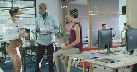 Coworkers Collaborating in Modern Open-Plan Office with Digital Graphics