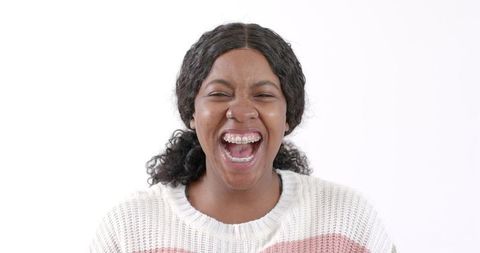 Joyful African American Woman Laughing in Cozy Sweater