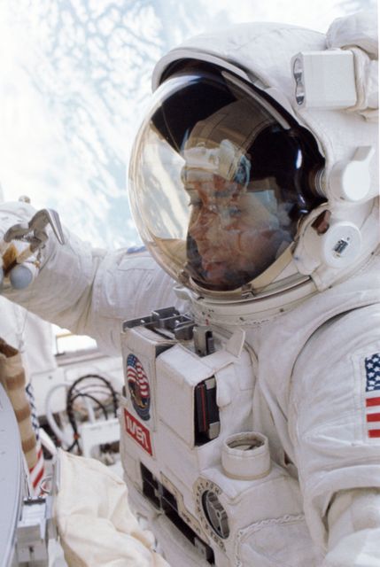 This image shows an astronaut conducting an extravehicular activity (EVA) from the space shuttle Challenger in 1984. The astronaut is wearing a spacesuit and working on the Orbital Refueling System in the aft cargo bay. Such historic images are ideal for space exploration presentations, educational materials, or articles on NASA missions and technological advancements in spaceflight.