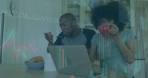 Couple Sharing Breakfast Using Laptop in Modern Kitchen Environment