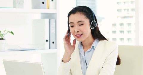 Asian Businesswoman Engaging Customers via Headset in Modern Office - Download Free Stock Images Pikwizard.com