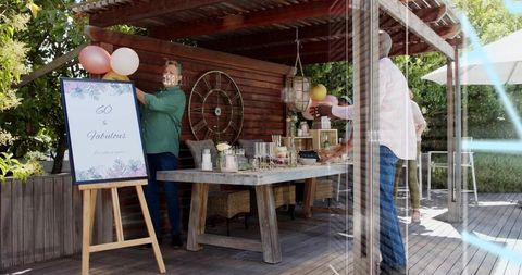 Preparing 60th Birthday Brunch on Rustic Backyard Pergola with Balloon Decor