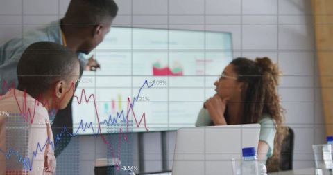 Team Analyzing Financial Data in Modern Office with Graph Overlay