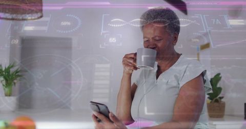 Senior woman sipping coffee while browsing smartphone with futuristic hud overlay
