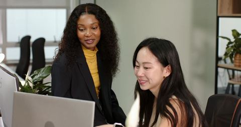 Diverse Coworkers Collaborating at Modern Office Desk