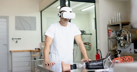 Engineer Testing Prosthetic with VR Headset in Modern Laboratory