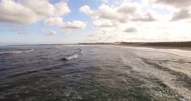 View of waves reaching a shore at beach on a sunny day 4k