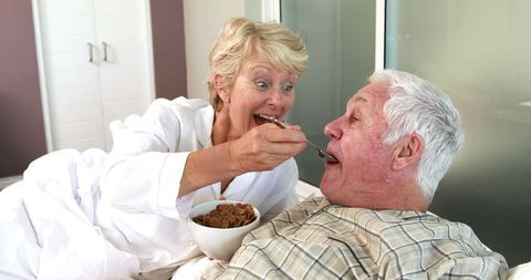Senior Couple Sharing Breakfast in Bed Laughing Together - Download Free Stock Images Pikwizard.com