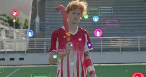 Athlete in red jersey holding hockey stick with digital interactions