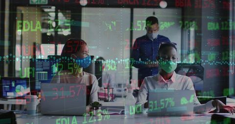 Diverse Coworkers Collaborating With Stock Market Analytics in Modern Office