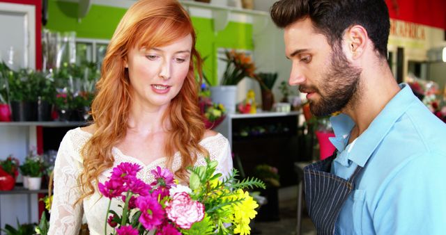 Florist assisting client selecting flower bouquet at flower shop - Download Free Stock Images Pikwizard.com