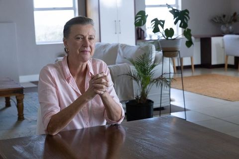 Serene woman sitting in bright minimalist living room