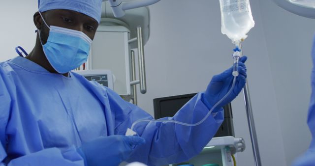 African American Surgeon Preparing IV Line in Operating Room - Download Free Stock Images Pikwizard.com