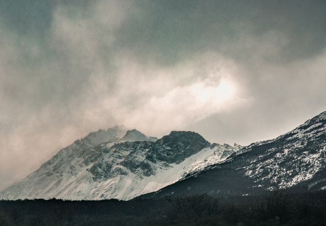 Misty Mountain Range with Snow-Covered Peaks in Winter - Download Free Stock Photos Pikwizard.com