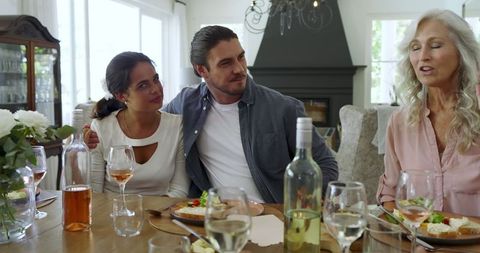 Family Enjoying Meal and Conversation at Dining Table