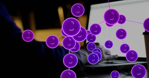 Violet molecular network overlaying laptop workspace with typing hand and coffee