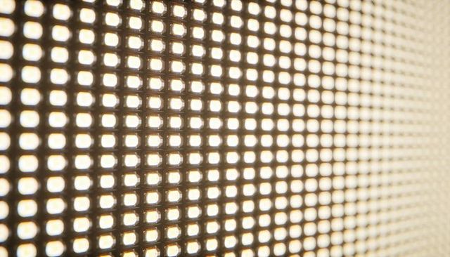 Warm led matrix closeup showing diagonal pixel grid with glowing diodes