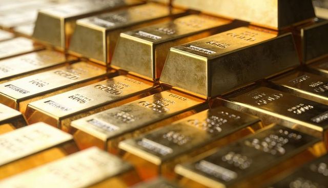 Glinting gold bars stacking with purity stamps and reflective luster for finance