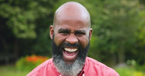 Smiling Man Enjoying Outdoor Garden in Red Shirt