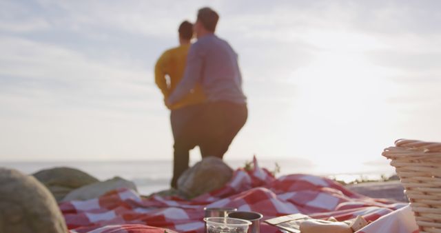 Couple Embracing During Beach Picnic at Sunset - Download Free Stock Images Pikwizard.com