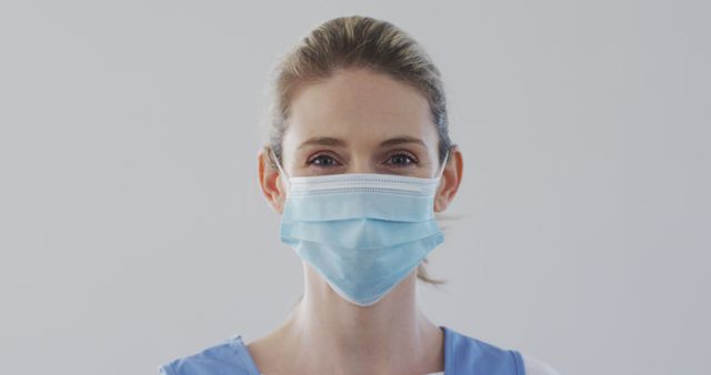 Female Healthcare Worker Wearing a Blue Medical Mask - Download Free Stock Images Pikwizard.com