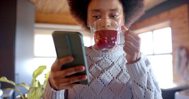 Woman Drinking Tea and Using Smartphone in Cozy Home Setting - Download Free Stock Images Pikwizard.com
