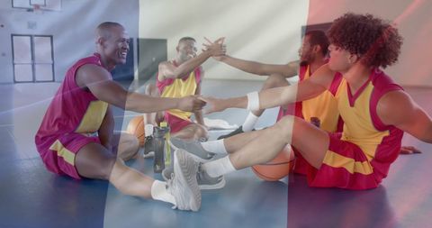 Diverse Basketball Team with French Flag Overlay Uniting in Gym