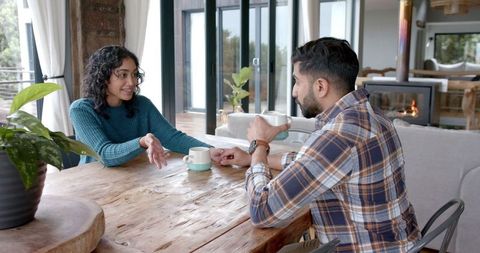 Couple Engaging Conversation Over Coffee at Home