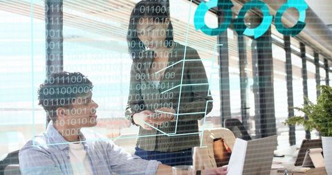 Collaborating team analyzing augmented reality data overlay in modern open-plan office