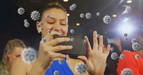 Woman at gala event with smartphone in pandemic atmosphere