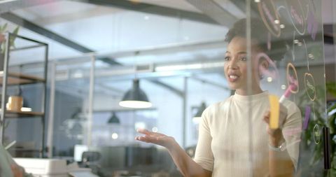 Confident Businesswoman Presenting at Modern Workspace