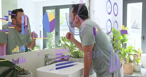 Mature asian man leaning at bathroom sink examining skin with augmented reality data overlays