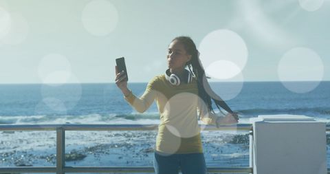 Woman Using Smartphone Taking Selfie by Ocean